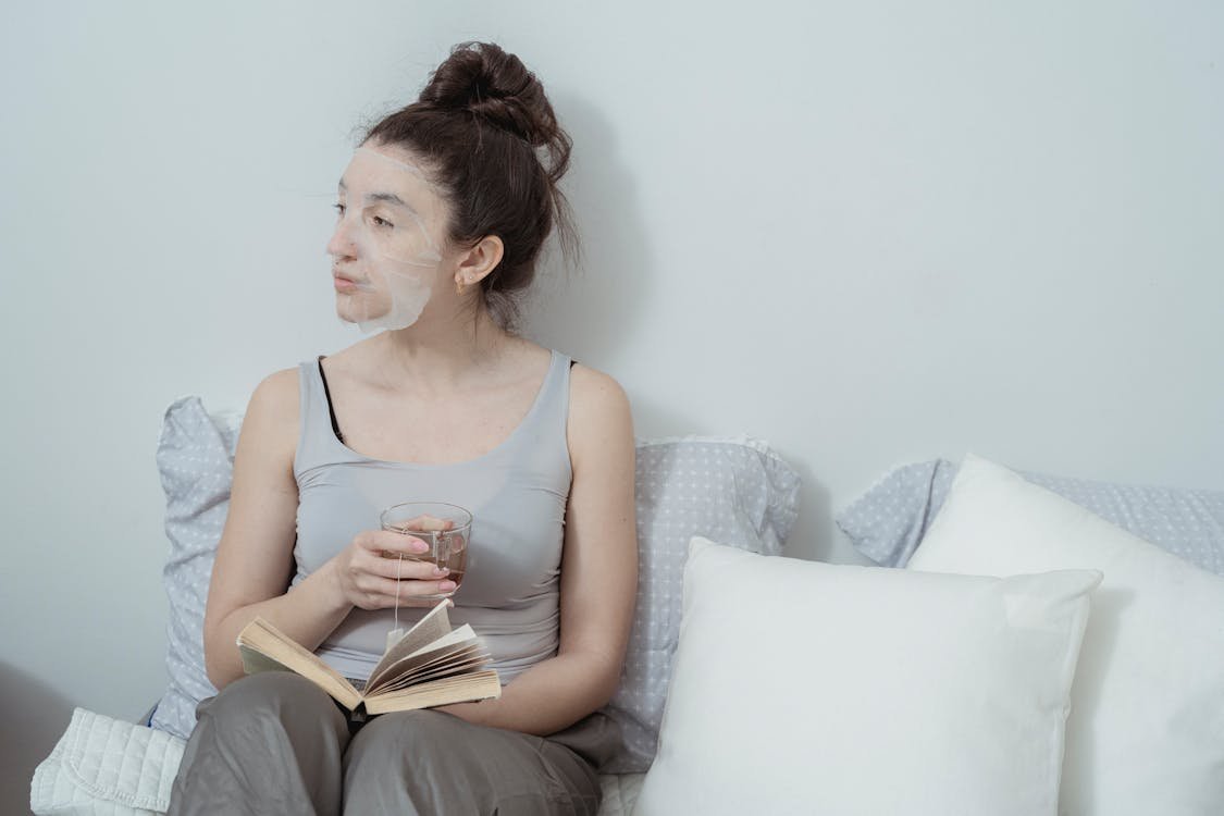 Free Woman Sitting with Skin Care Face Mask Stock Photo