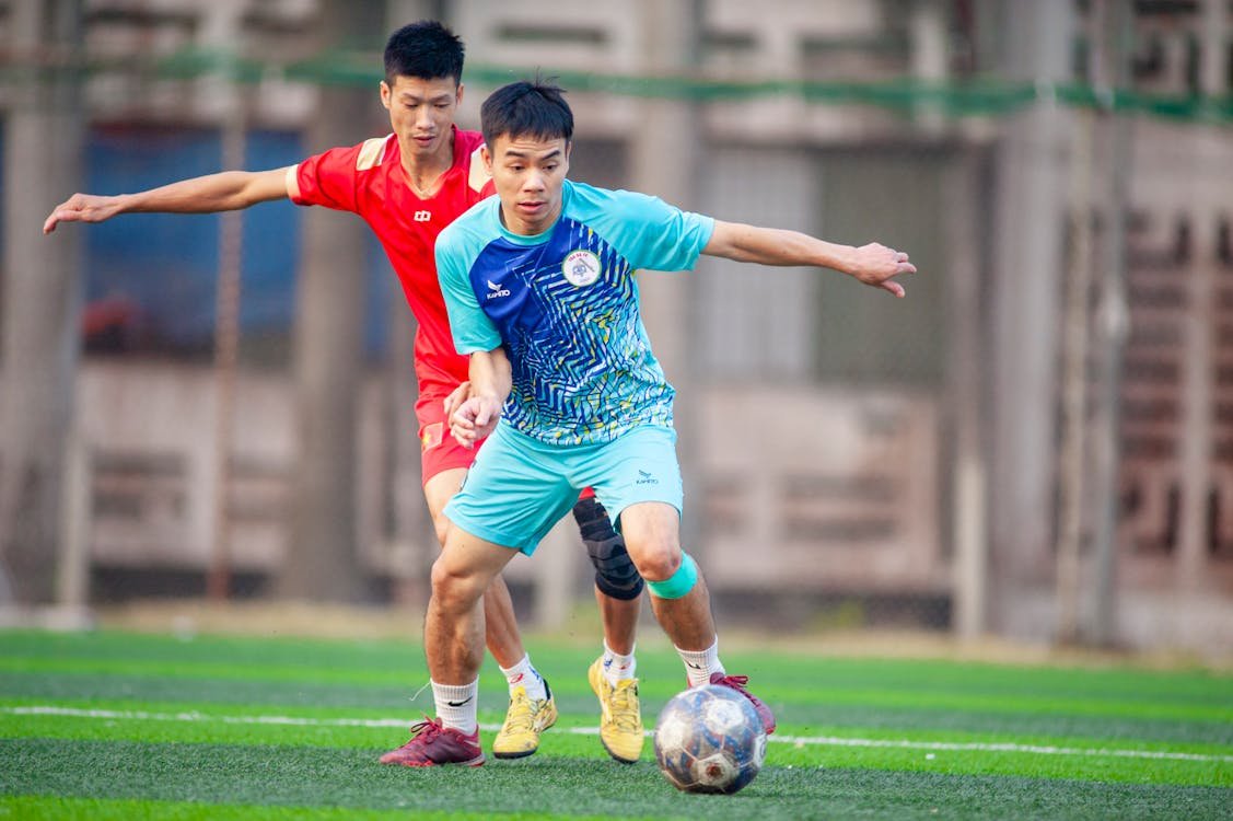 Free Two soccer players compete intensely during a game in Hanoi, Vietnam. Stock Photo